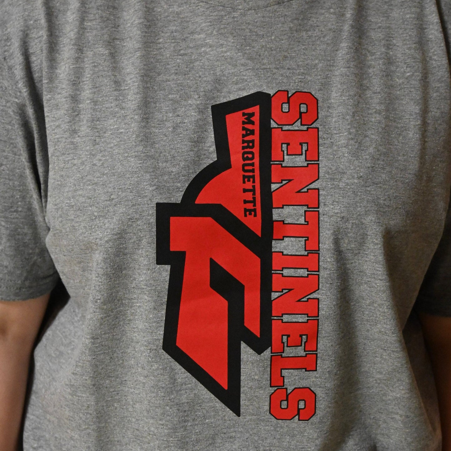 Half Sentinel helmet with "Sentinels" written vertically on Dark Grey T-Shirt