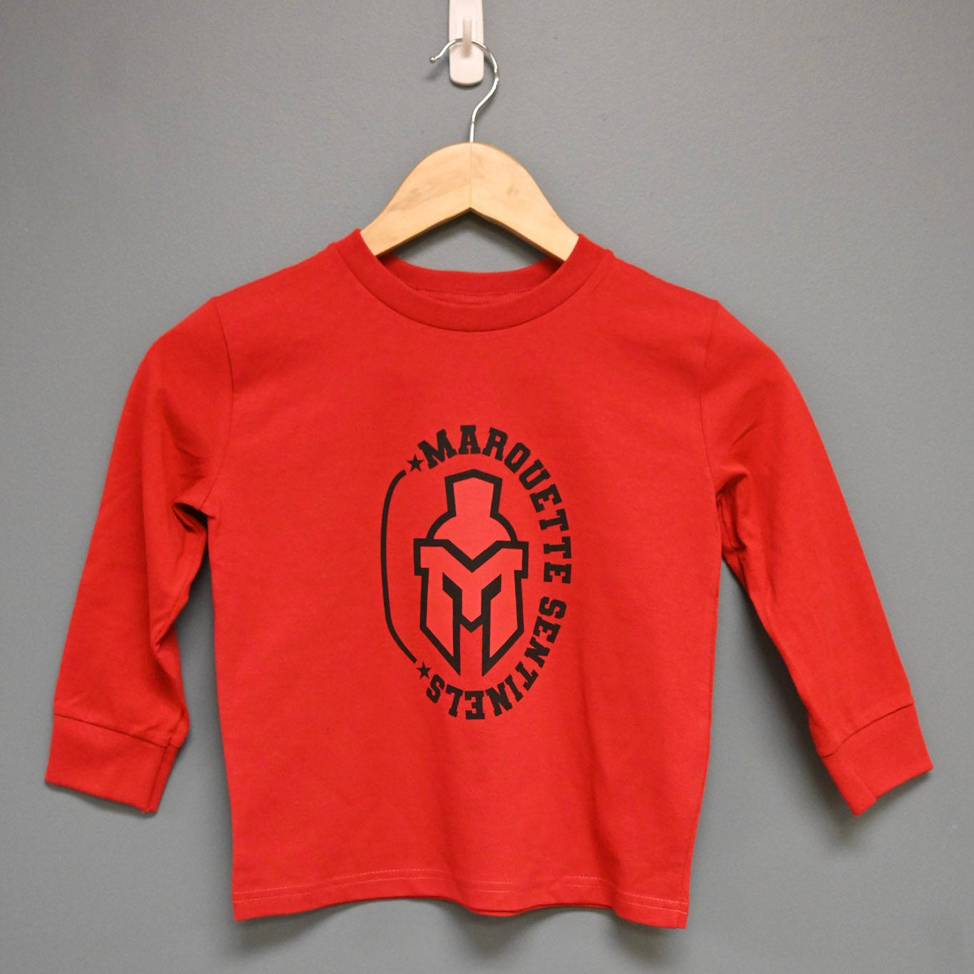 Long sleeve red shirt with Marquette Sentinels "helmet and stars" design