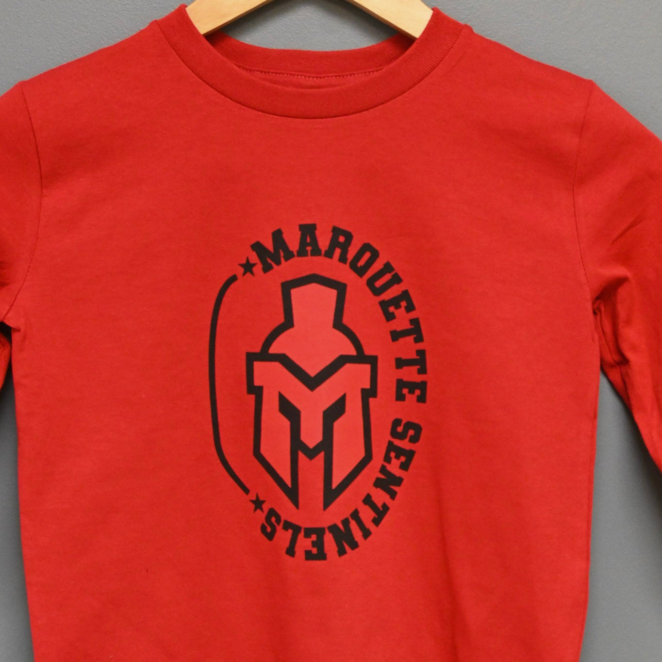 Long sleeve red shirt with Marquette Sentinels "helmet and stars" design