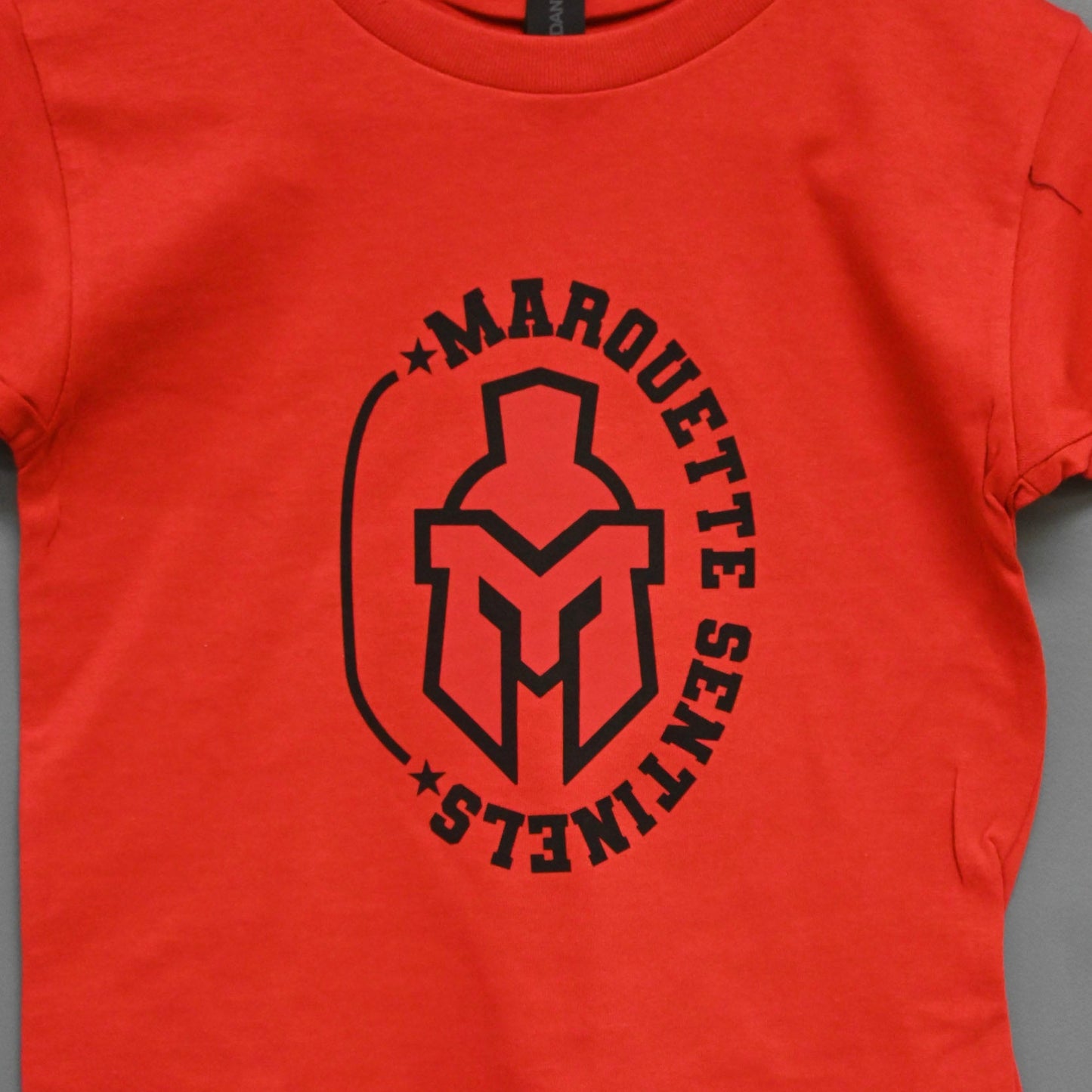 Short Sleeve red shirt with Marquette Sentinels "helmet and Stars" design