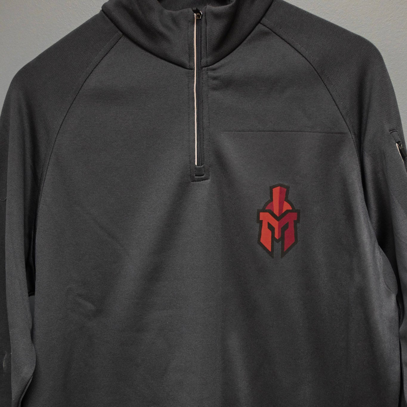 Pocket Sentinel helmet on charcoal gray polyester Quater Zip