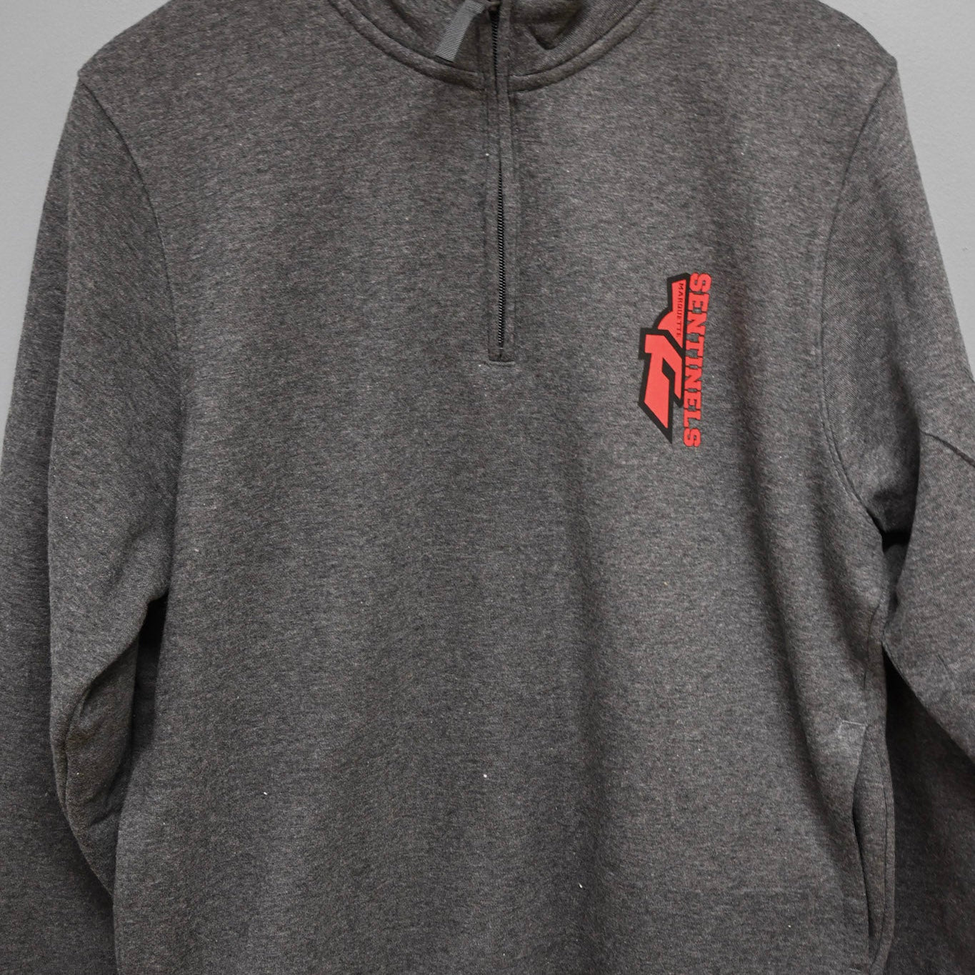 Half Sentinel Helmet with "Sentinels"written out pocket design on Quarter Zip